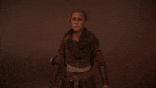 a woman with a scarf around her neck is standing in the dark