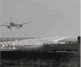 a plane is taking off from an airport runway in the fog