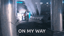 a group of people are walking through a tunnel with the words on my way written on the bottom .