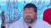 a man with a beard is making a funny face while wearing a white shirt and tie