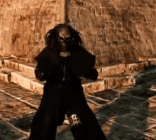 a video game character standing in front of a stone wall
