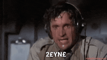 a man wearing headphones has a tear running down his face and says zeyne