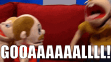 a couple of puppets are sitting on a red couch and one of them says gooaaaaaalll !
