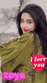 a woman in a green dress with a heart that says i love you