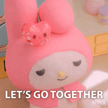 a pink stuffed animal with the words let 's go together written below it
