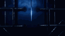 a person is standing in a dark room with blue smoke coming out of the ceiling .