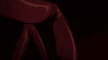 a woman with long red hair is standing in the dark with her arm outstretched