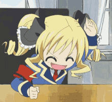 a cartoon girl with blonde hair is sitting at a table
