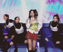 a woman is singing into a microphone while dancing on stage