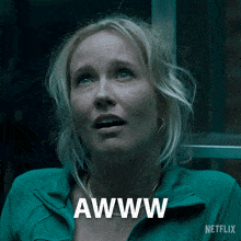 a woman in a green jacket says awww on the bottom
