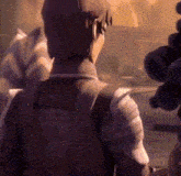 a man is standing in front of a stuffed animal in a video game .