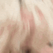 a close up of a woman 's face with blonde curly hair .