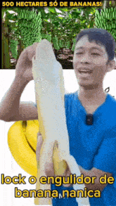 a man in a blue shirt is holding a banana in front of a banana plantation