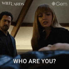 a man and woman are standing next to each other and the woman is asking the man who are you