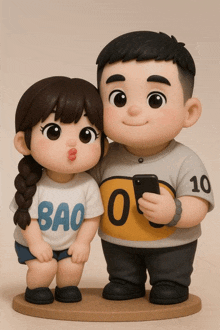 a boy and a girl are standing next to each other and the girl is wearing a bao shirt