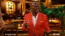a man in a red jacket with a tag that says taco