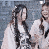 two girls are standing next to each other and one of them is wearing a shirt that says " love " on it