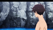 a man without a shirt is standing in a body of water