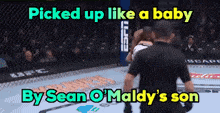 a man in a boxing ring with the words picked up like a baby by sean o maldy 's son