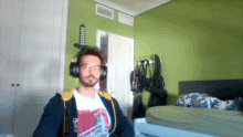 a man wearing headphones and a t-shirt that says ' tf ' on it