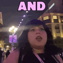 a woman standing in front of a building with the word and above her
