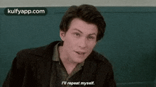 a young man is sitting in a chair and saying `` i 'll repeat myself `` .