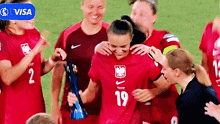 a soccer player with the number 19 on her shirt