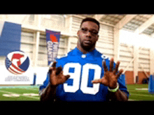 a man wearing a blue jersey with the number 90 on the front