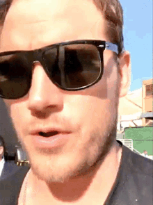 a close up of a man wearing sunglasses