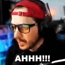 a man wearing glasses and a red hat says ahh !!!