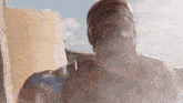 a close up of a statue of a man in a gas mask standing in front of a building .