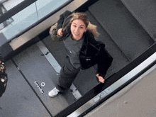 a woman is riding an escalator with schneider written on it
