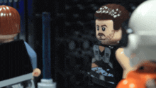 a lego figure with a beard is standing next to a white figure