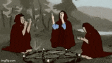 three witches are sitting around a circle with candles in it