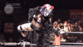 a woman in a mask is jumping over a rope in front of a sign that says stardomworld