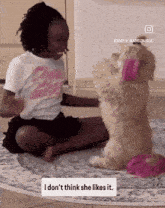 a girl in a barbie shirt sits next to a dog