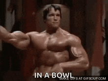 arnold schwarzenegger is flexing his muscles in a gif .