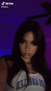 a tiktok video of a girl with long nails and a nose ring