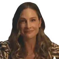 a woman in a zebra print shirt is smiling