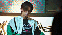 a young man wearing a t-shirt that says ' racket net ' on it