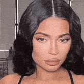 a close up of a woman 's face with black hair and a wig .