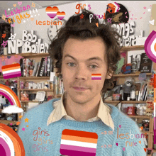 harry styles is wearing a blue sweater with a lesbian flag on his face