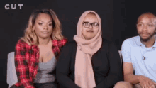 a group of people are sitting in front of a black background with the word cut above them