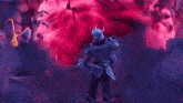 a man in armor holding a sword in front of a pink background