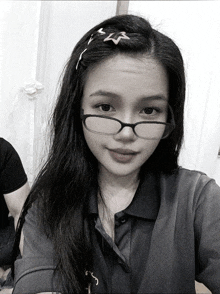 a woman wearing glasses and a hair clip has a star in her hair