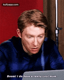 a man is sitting in front of a laptop computer and saying `` boom ! i do have a really cool mum '' .
