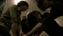 a group of people are fighting with the letter d visible in the lower right corner