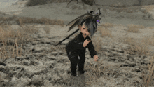 a cartoon character is kneeling in the dirt
