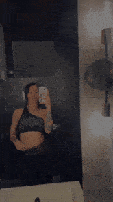 a woman taking a picture of herself in a mirror