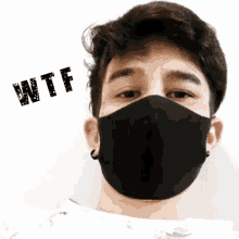 a man wearing a black face mask with the word wtf written on the bottom